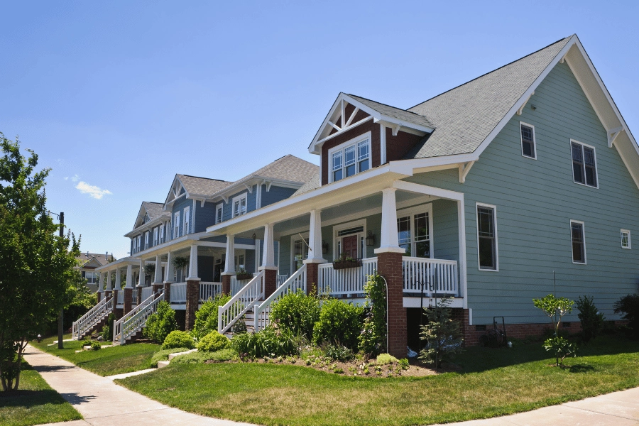 row of homes with front porches in quiet neighborhood